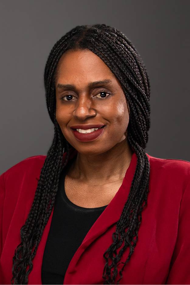 Dani Kimera smiling for a professional headshot